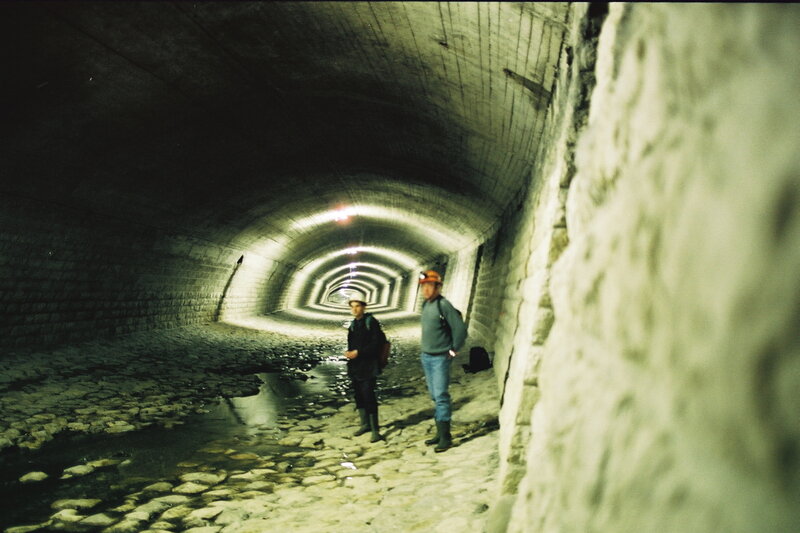 Explorers in a stone tunnel