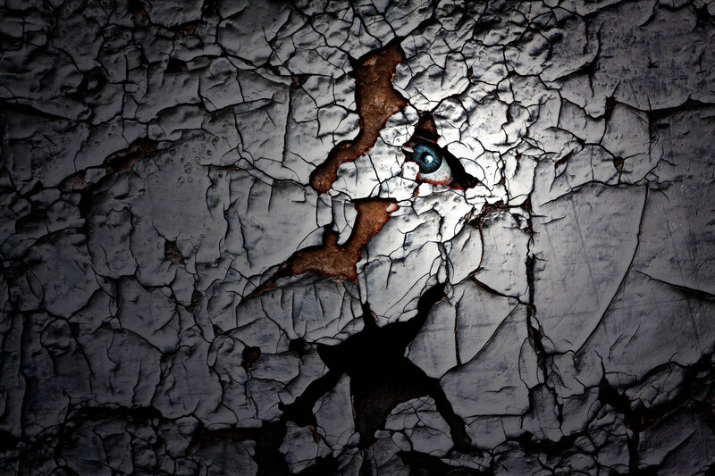 Eye Behind Cracked Paint