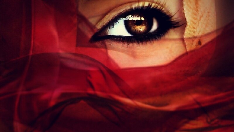 eye behind red fabric