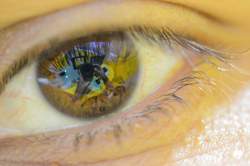 Eye reflection of photographer