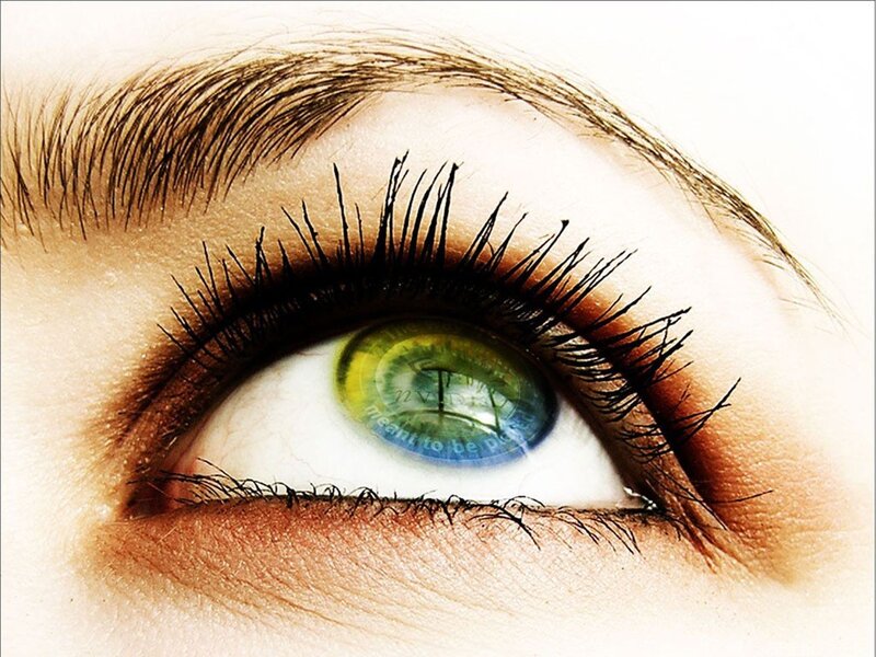 eye with green iris reflection