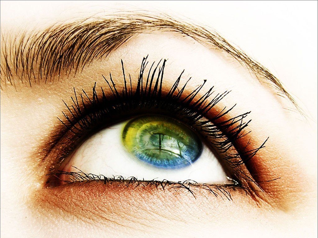 eye with green iris reflection