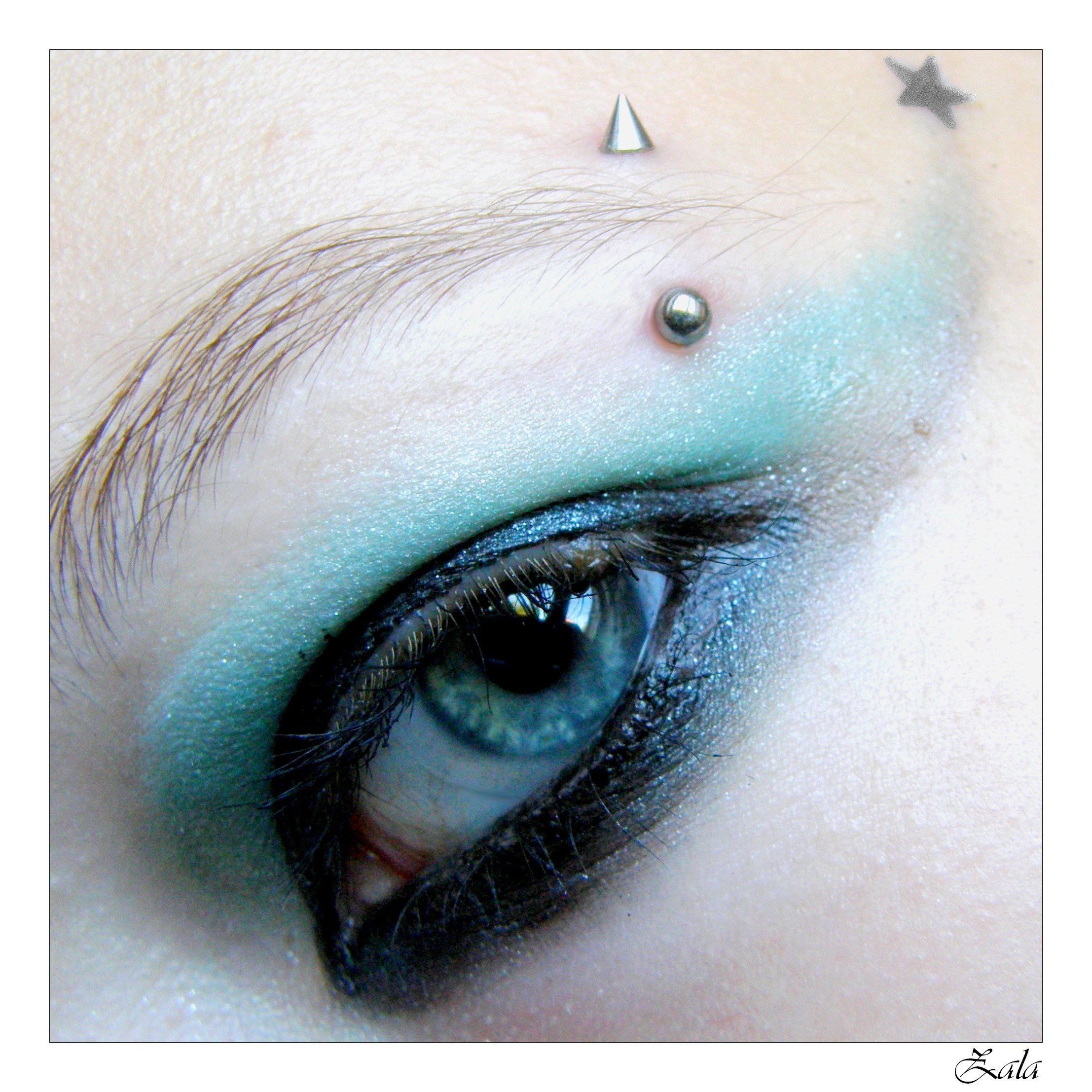 eye with piercings and makeup