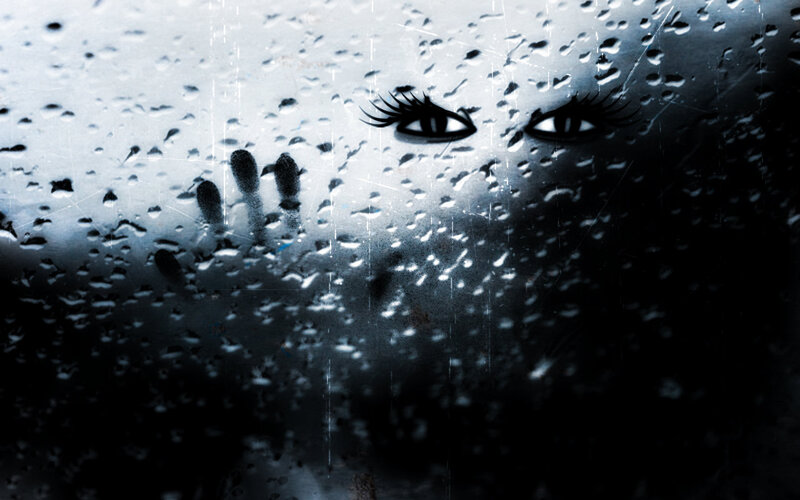 Eyes and Hand on Wet Glass