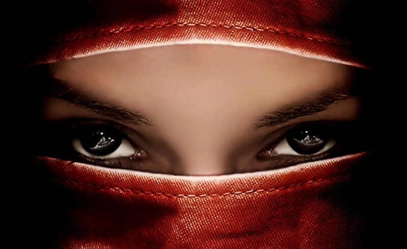 Eyes Behind Red Fabric