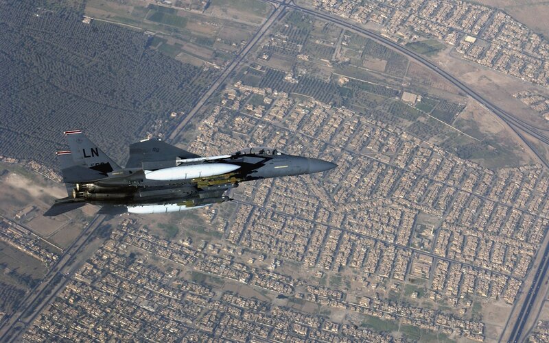 F-15 fighter jet over city