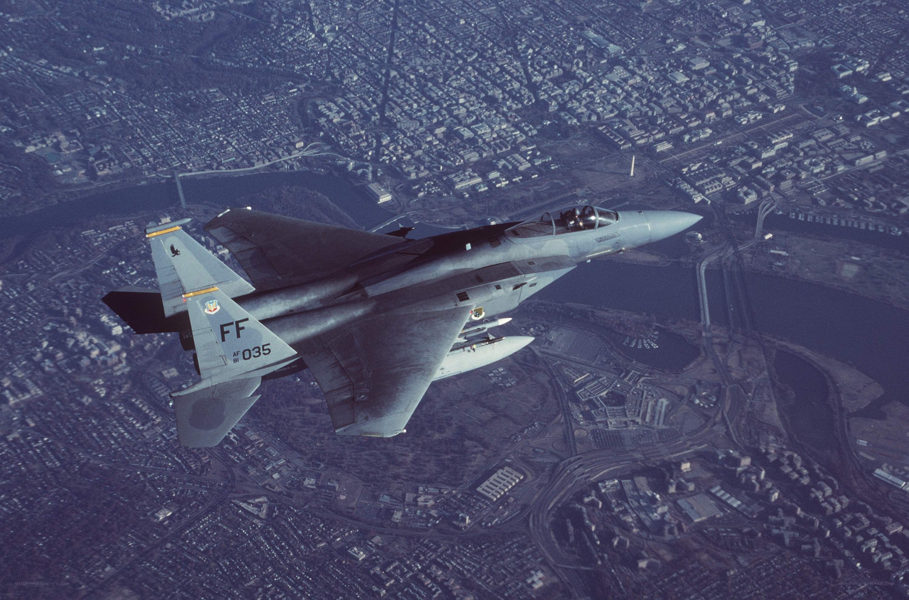 F-15 fighter jet over city
