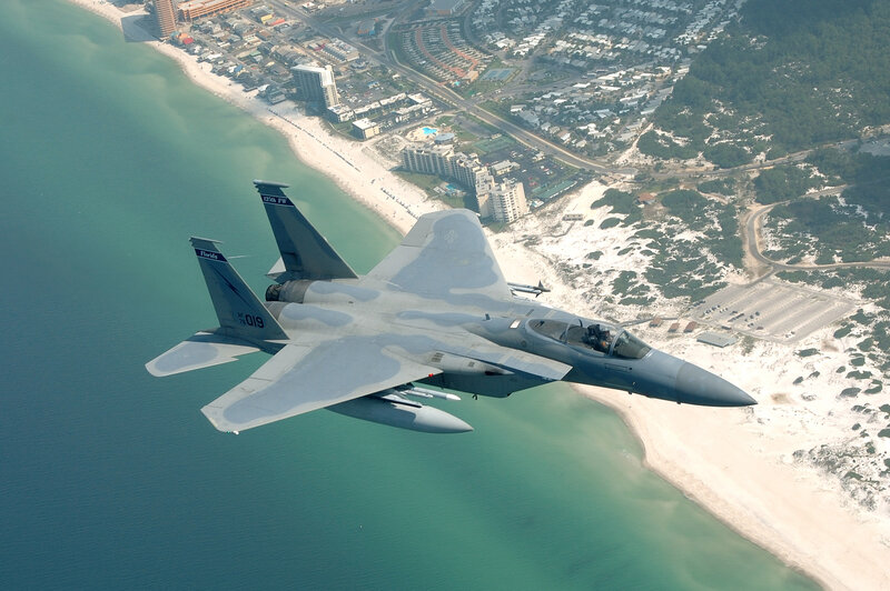 F-15 fighter jet over coastal area