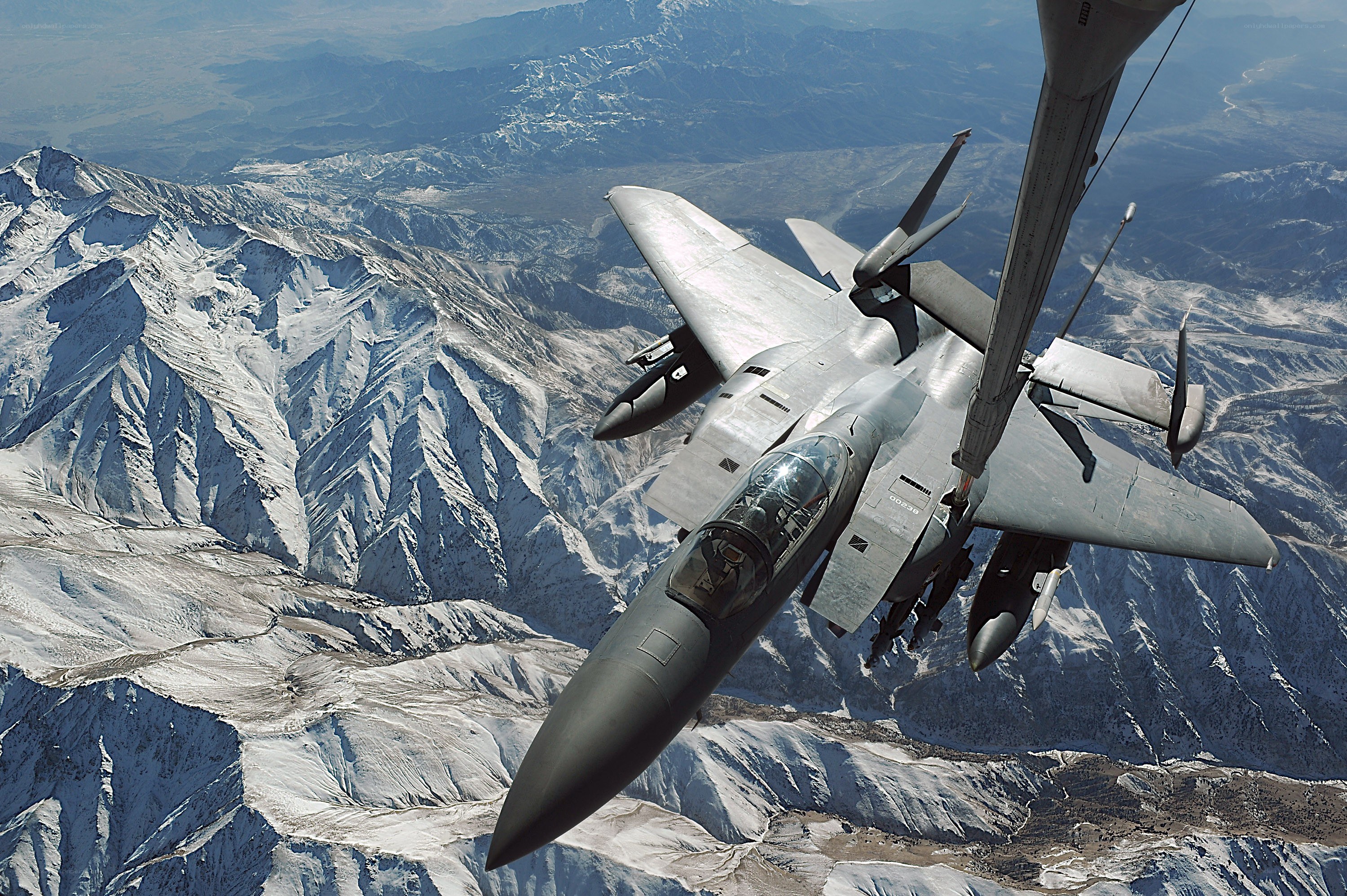 F-15 fighter jet over mountains