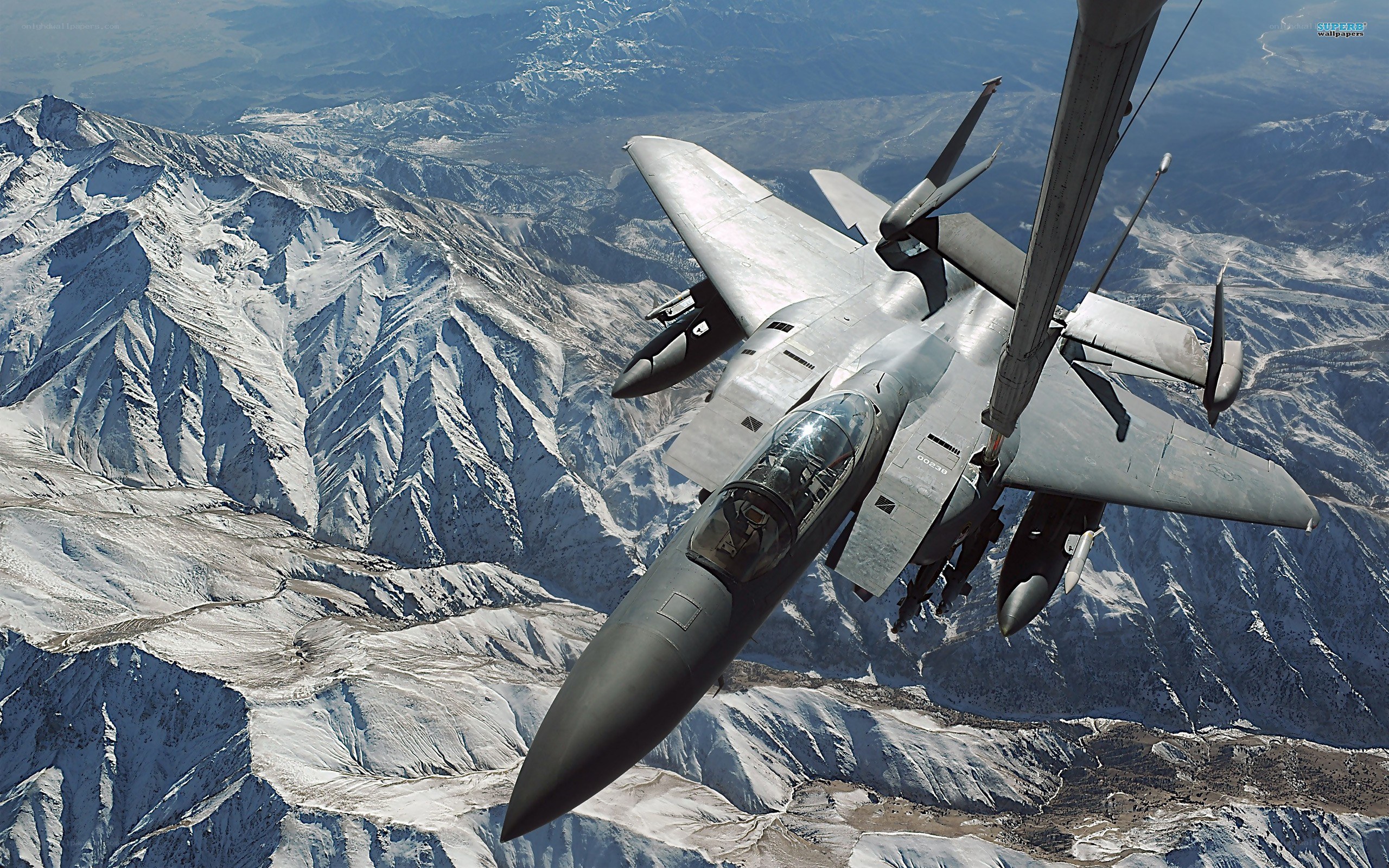 F-15 fighter jet over mountains