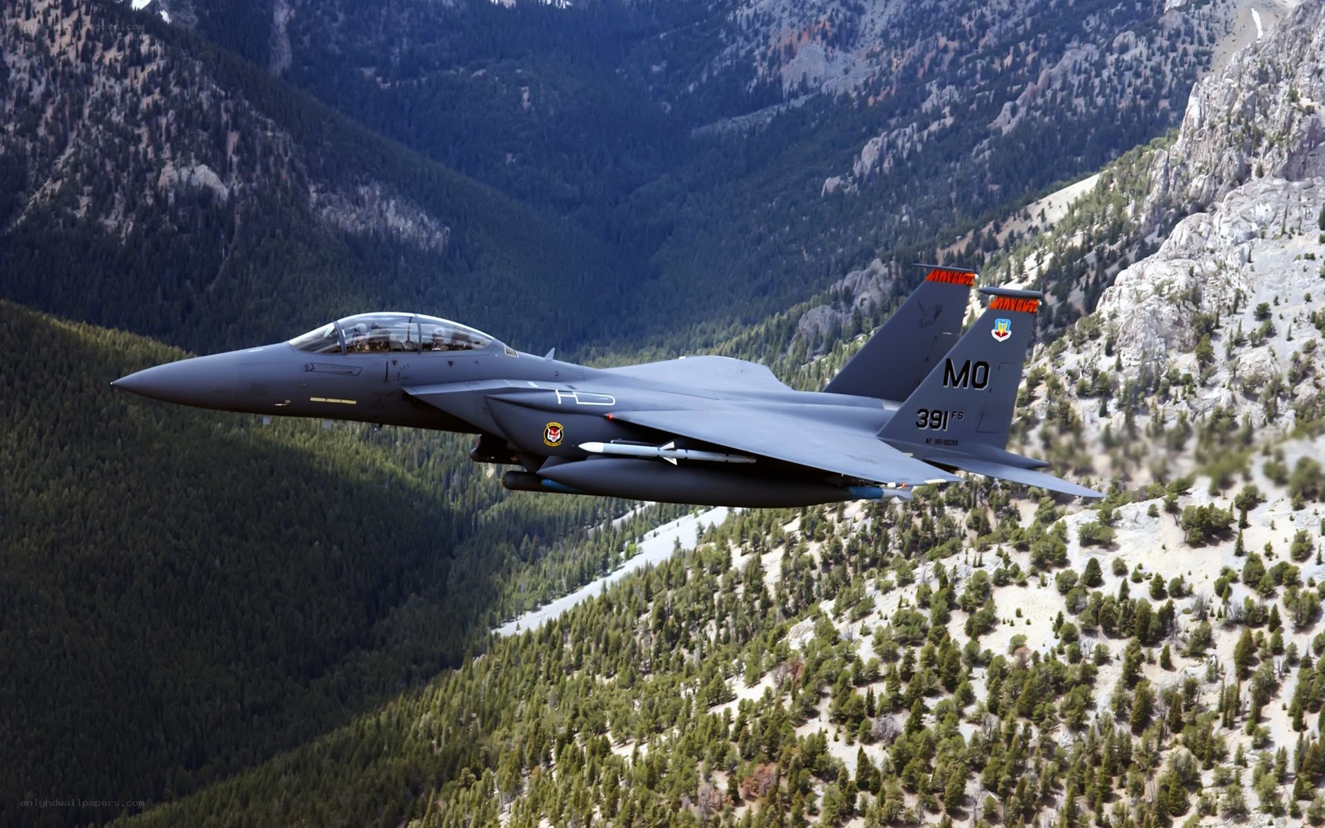F-15 fighter jet over mountains