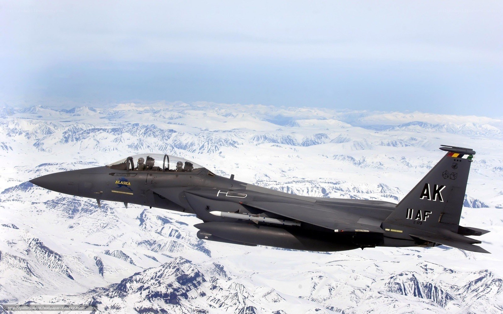 F-15 fighter jet over snowy mountains