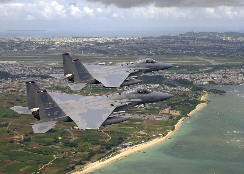 F-15 fighter jets over coastal city