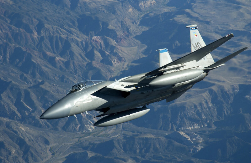 F-15E Fighter Jet — Gray, Dramatic, Afternoon, Photograph, Mountain Range