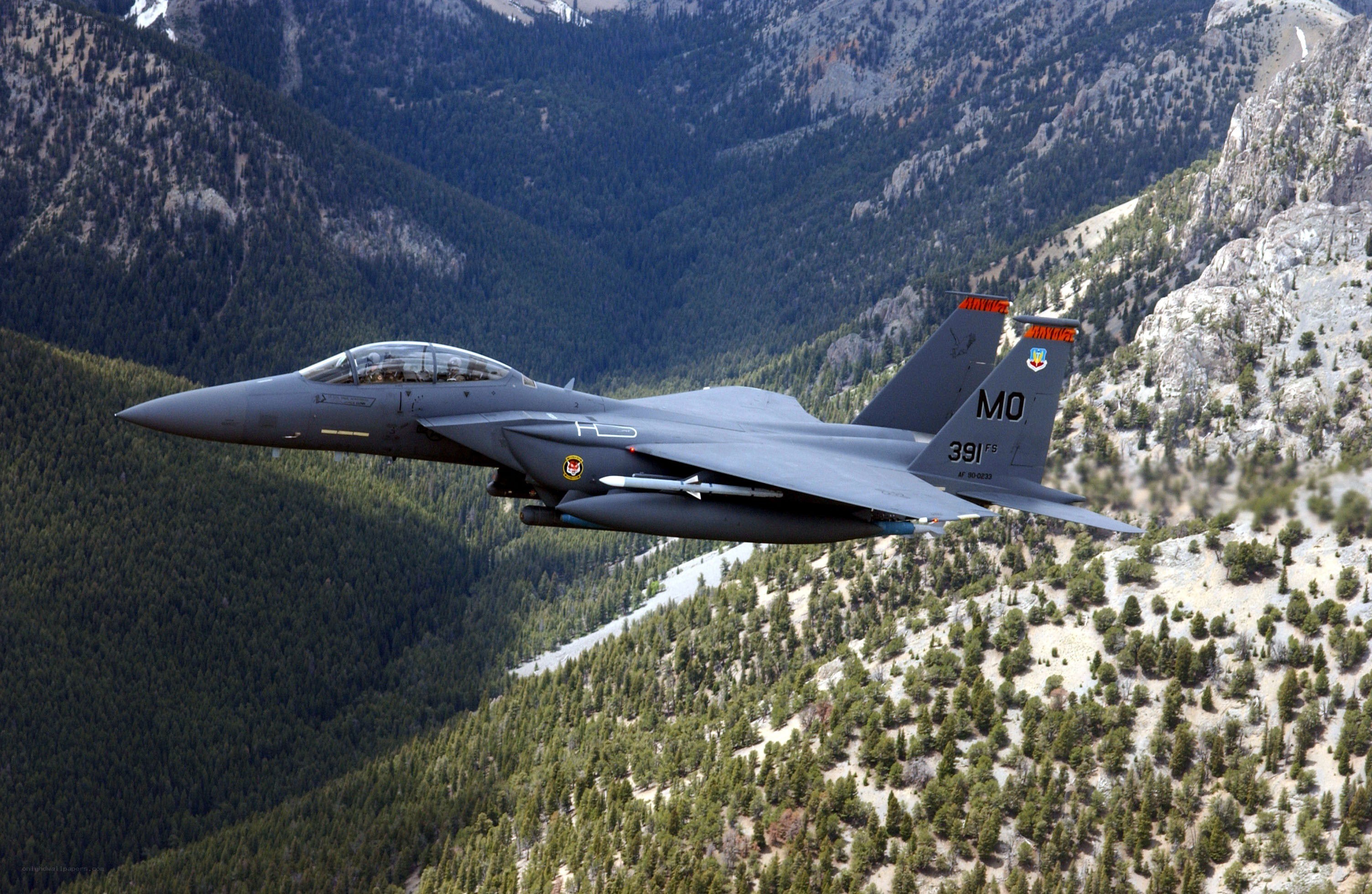 F-15E fighter jet over mountains
