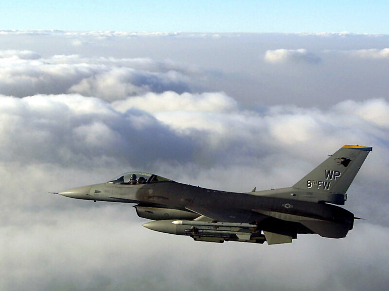 F-16 fighter jet above clouds