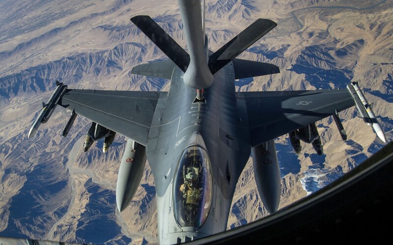 F-16 Fighter Jet — Gray, Dramatic, Afternoon, Photograph, Mountainous Terrain, Aircraft