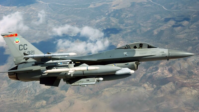 F-16 Fighter Jet — Gray, Dramatic, Afternoon, Photograph, Mountainous Terrain