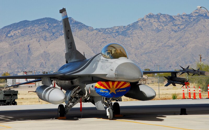 F-16 Fighter Jet — Gray, Dramatic, Afternoon, Photograph, Mountains, Aircraft Carrier