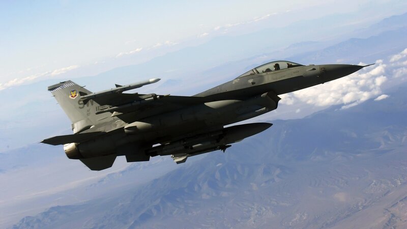 F-16 Fighter Jet — Gray, Dramatic, Afternoon, Photograph, Mountains, Clouds, Pilot