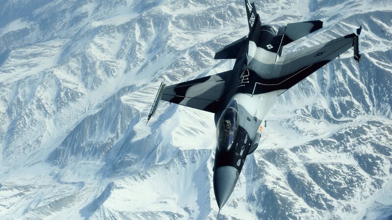 F-16 Fighter Jet — Gray, Dramatic, Photograph, Snow-covered Mountains