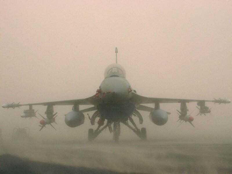 F-16 fighter jet on foggy runway