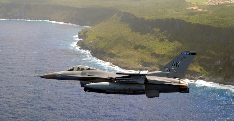 F-16 fighter jet over coastline