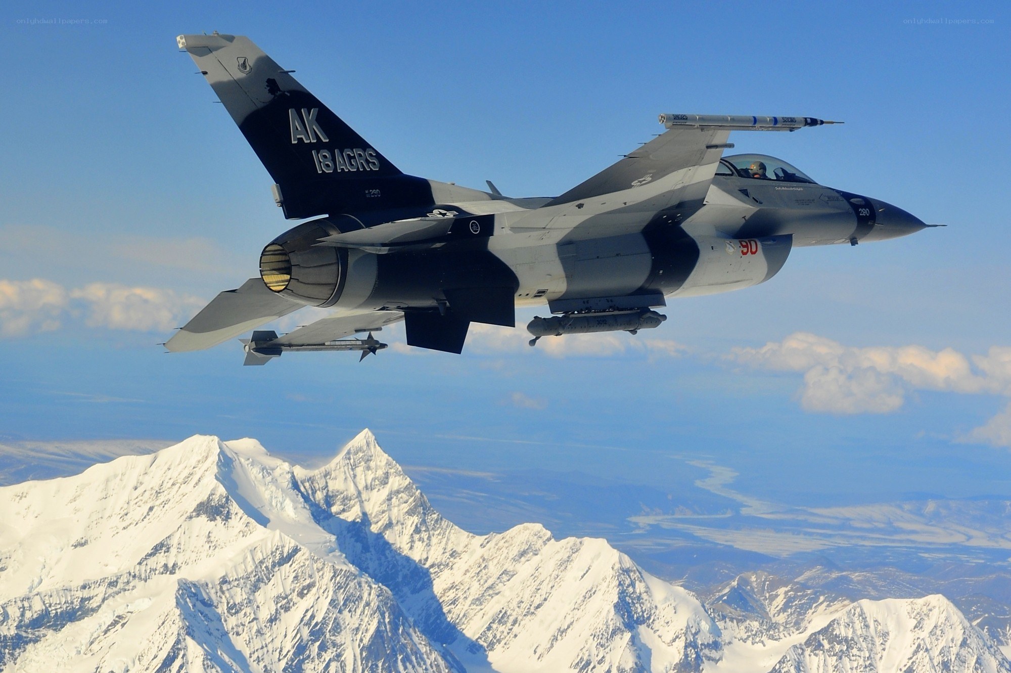 F-16 fighter jet over mountains