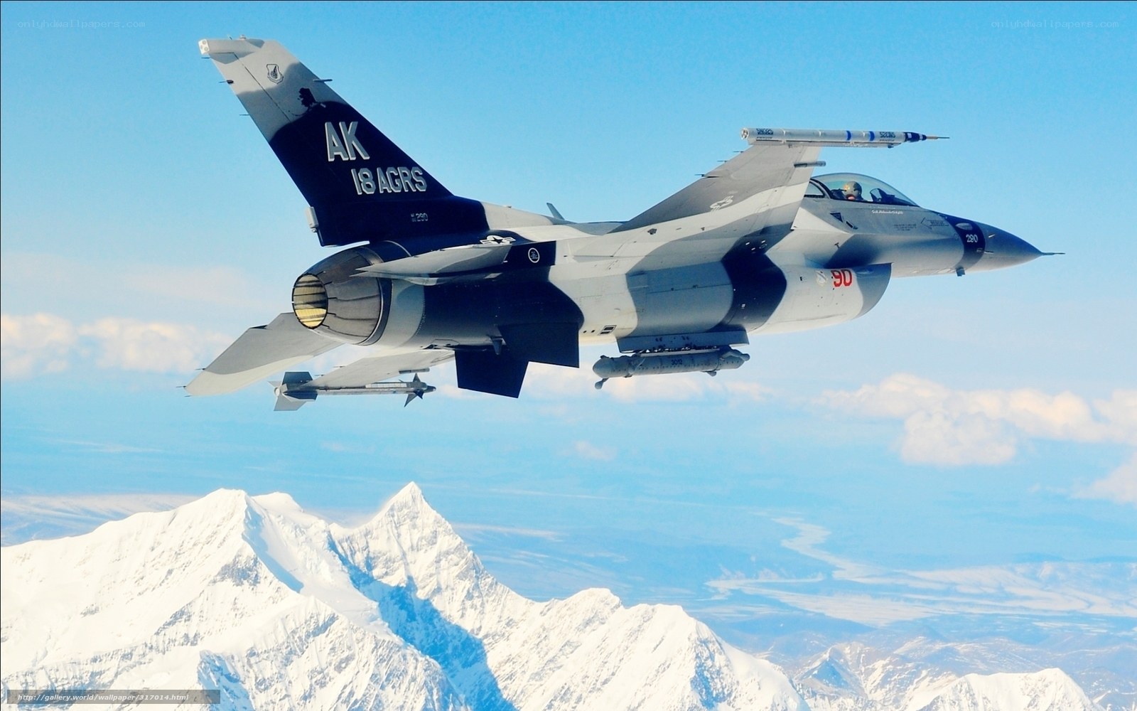 F-16 fighter jet over mountains