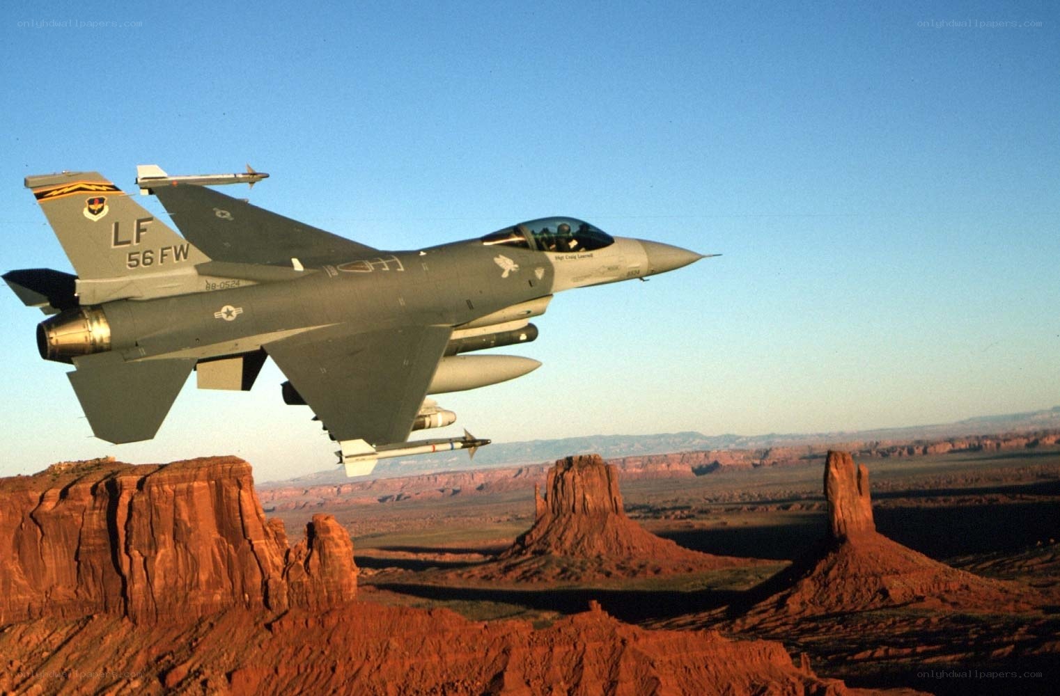 F-16 fighter jet over red rock