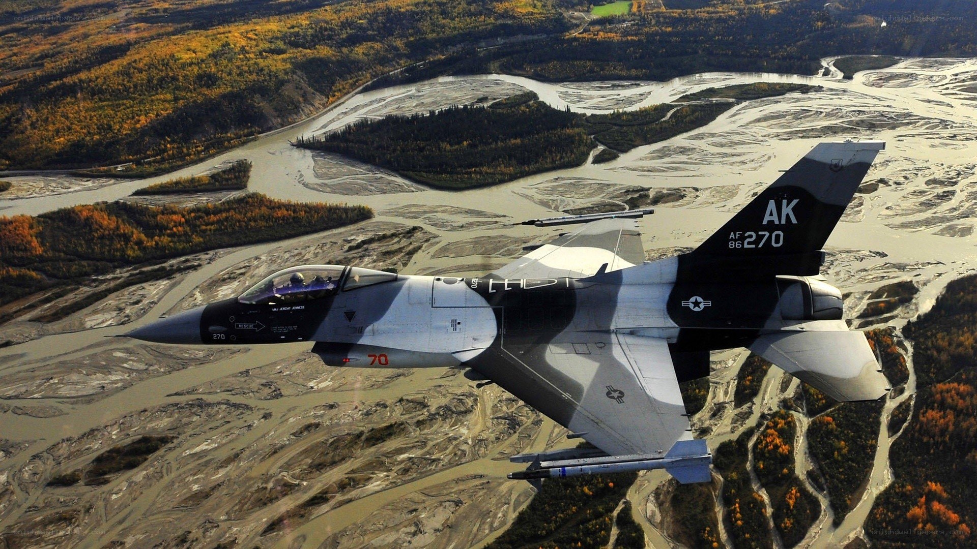 F-16 fighter jet over river