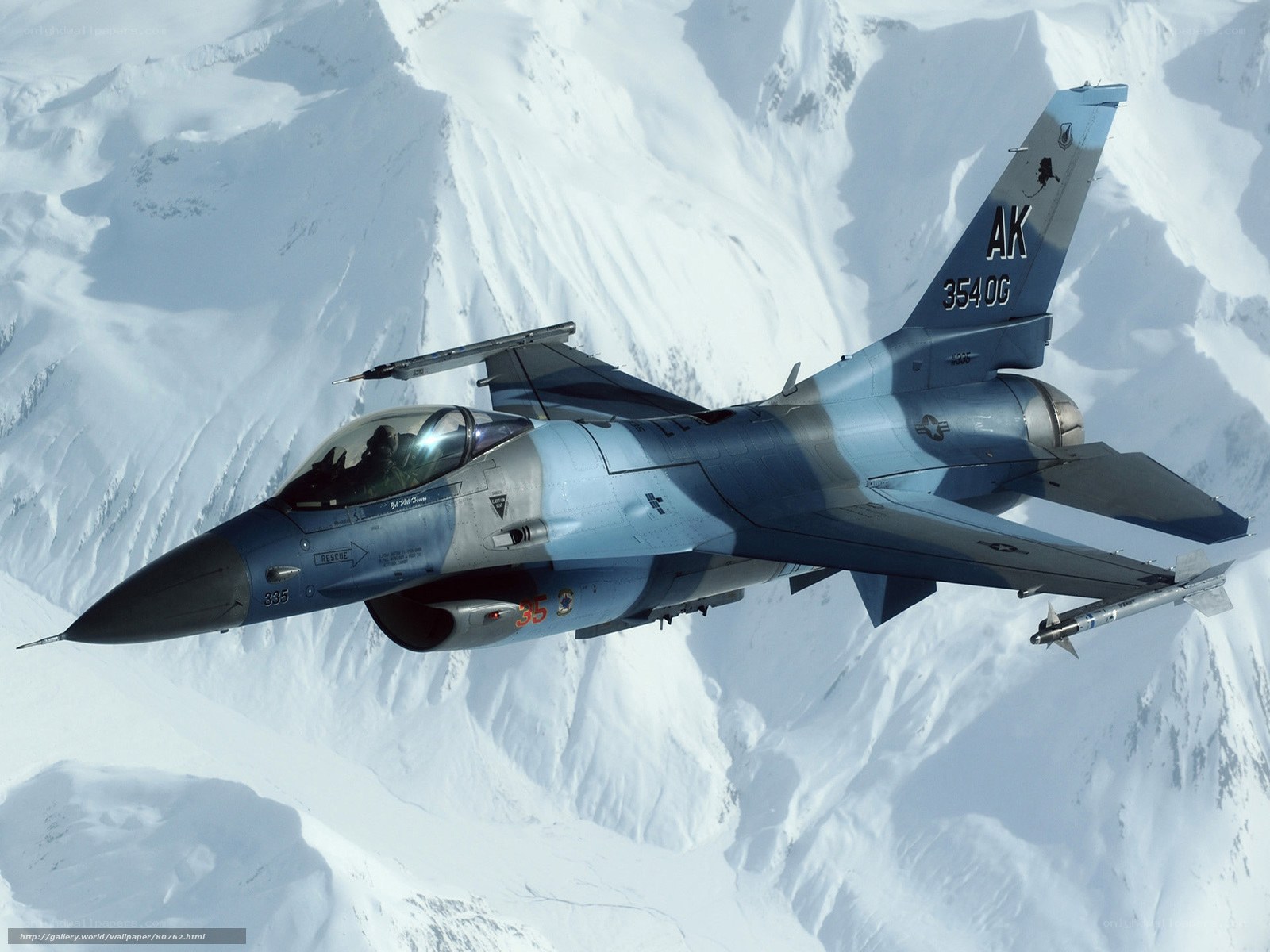 F-16 fighter jet over snowy mountains