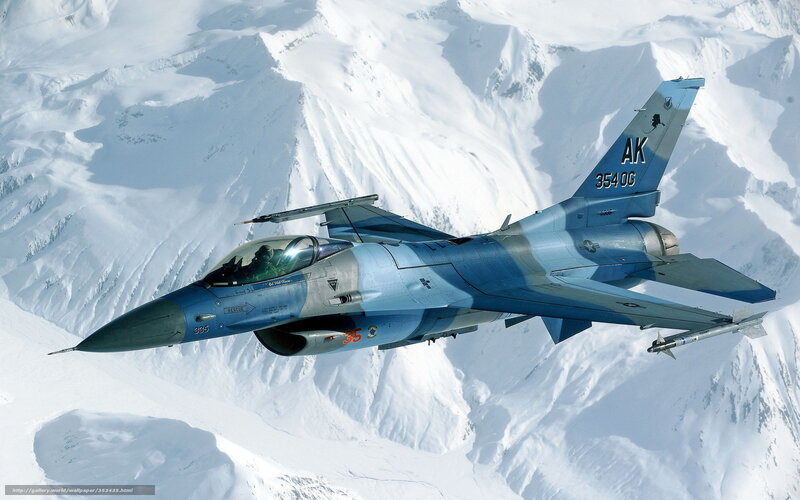F-16 fighter jet over snowy mountains