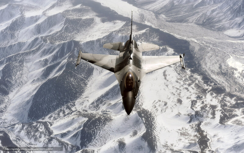 F-16 fighter jet over snowy mountains