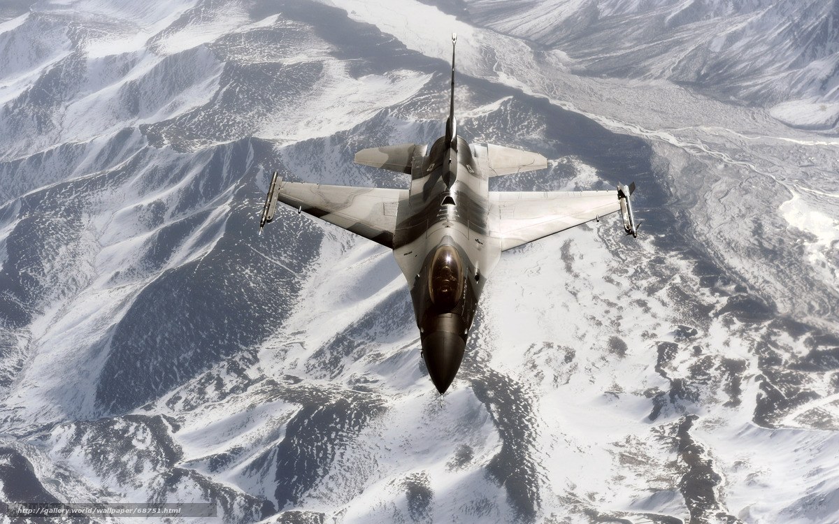 F-16 fighter jet over snowy mountains
