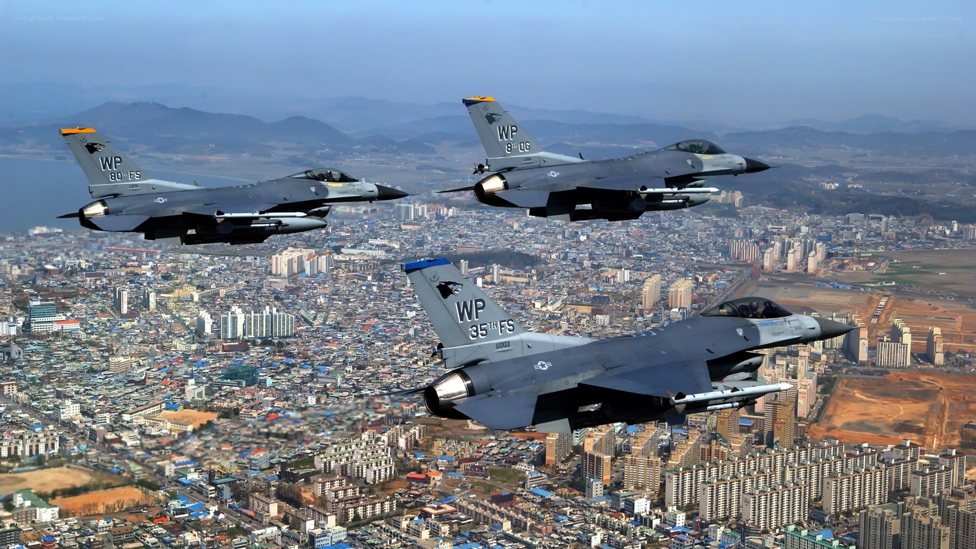 F-16 fighter jets over city