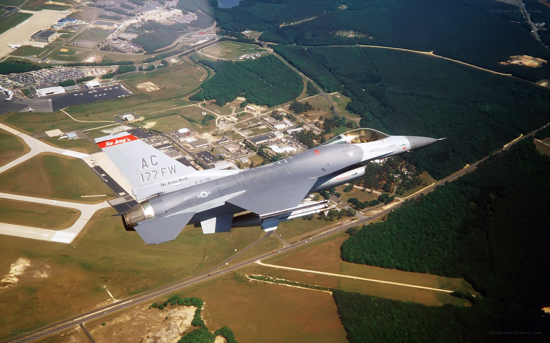 F-16 jet flying over airbase