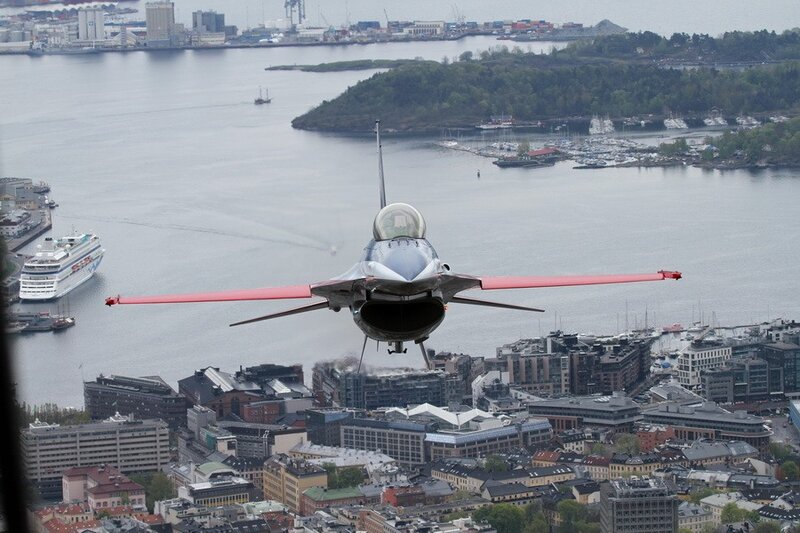 F-16 jet flying over city