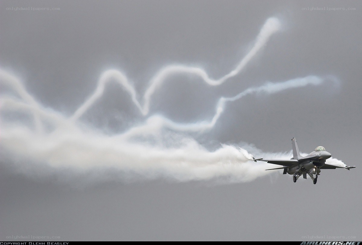 F-16 jet in flight with smoke trails