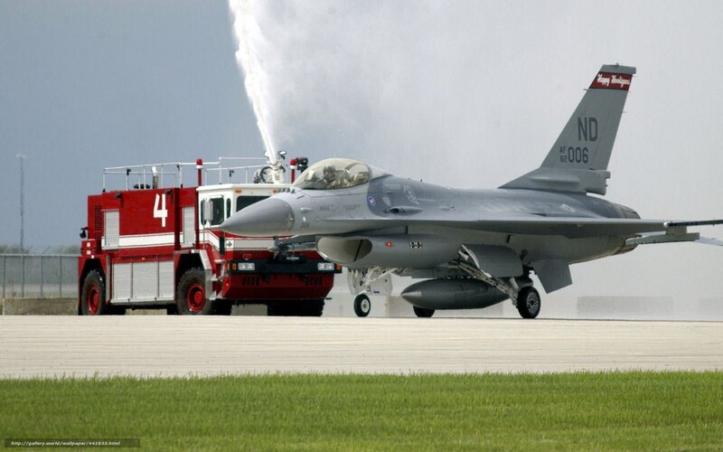 F-16 jet on tarmac with fire truck