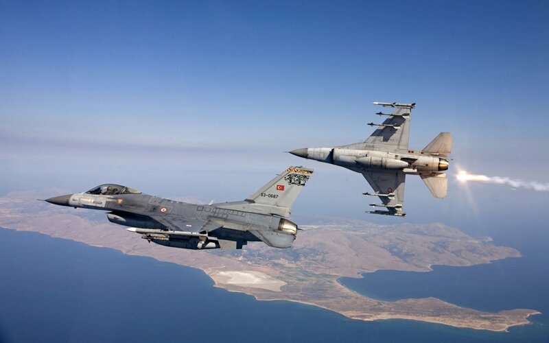 F-16 jets in flight over coastline