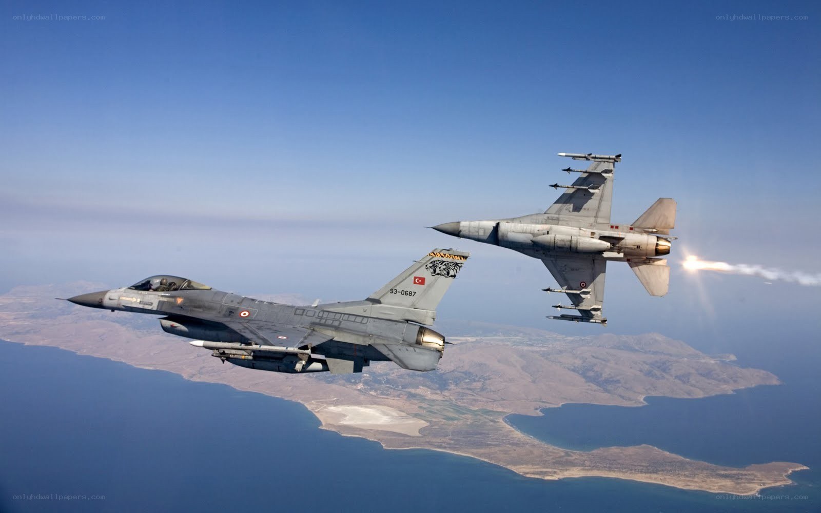 F-16 jets in flight over coastline