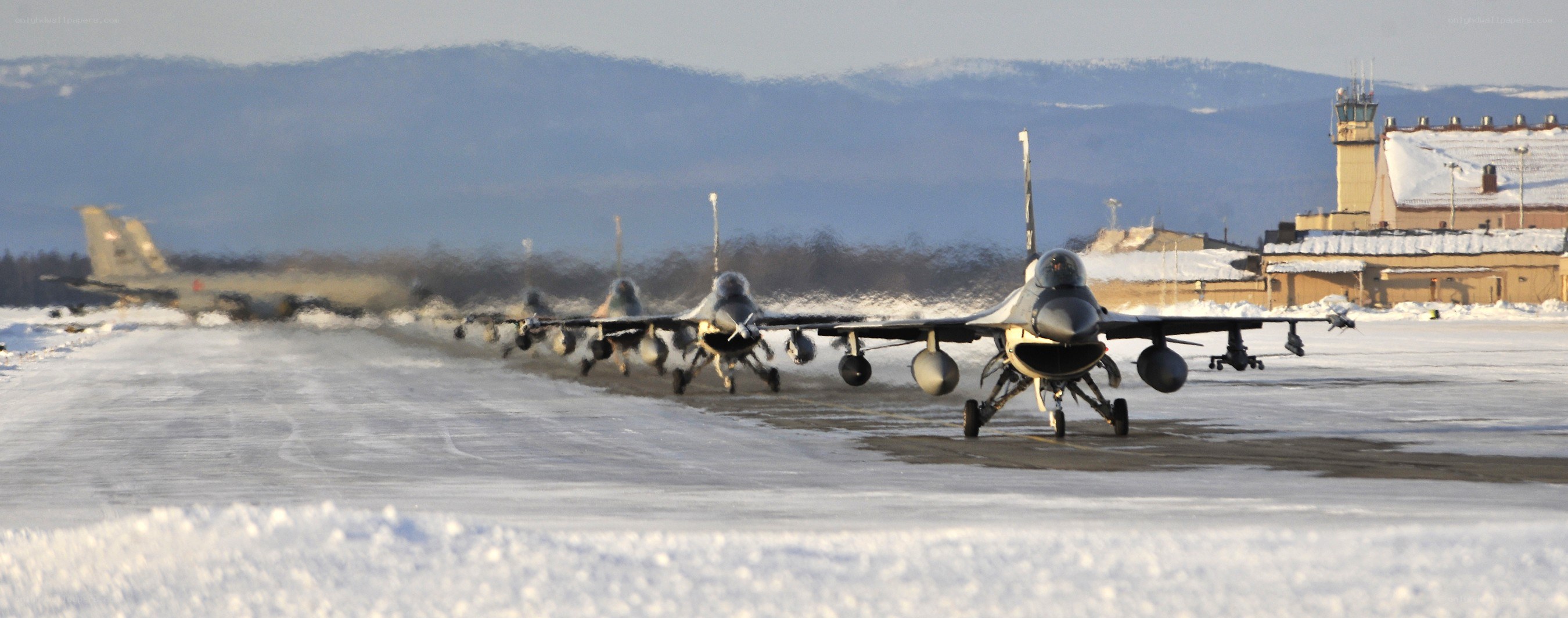 F-16 jets on snowy runway