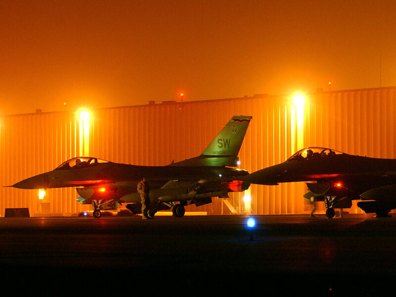 F-16 jets on tarmac at night