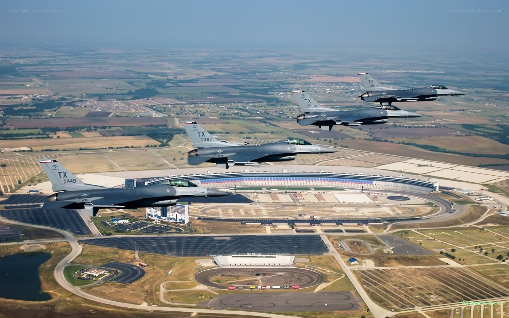 F-16s flying over a racetrack