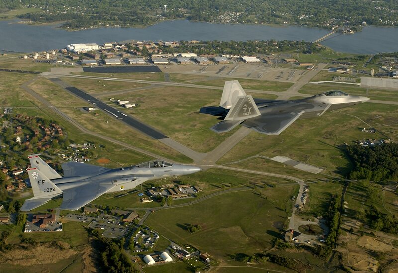 F-22 and F-15 jets over airbase