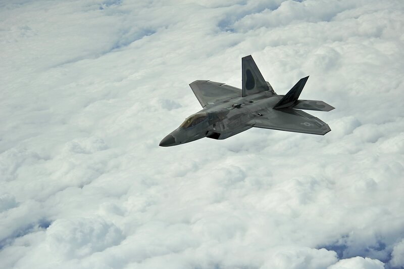 F-22 Raptor flying above clouds