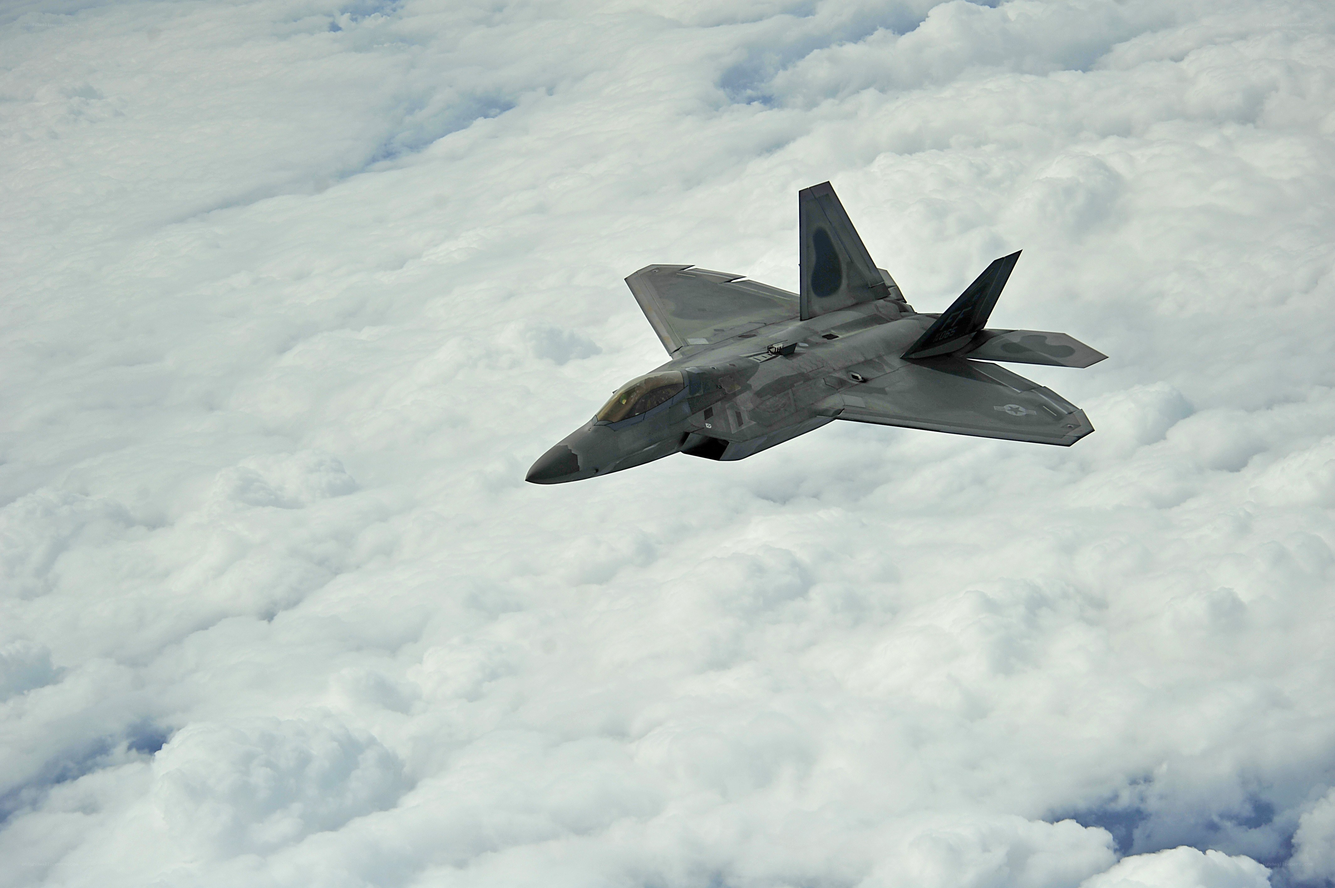 F-22 Raptor flying above clouds