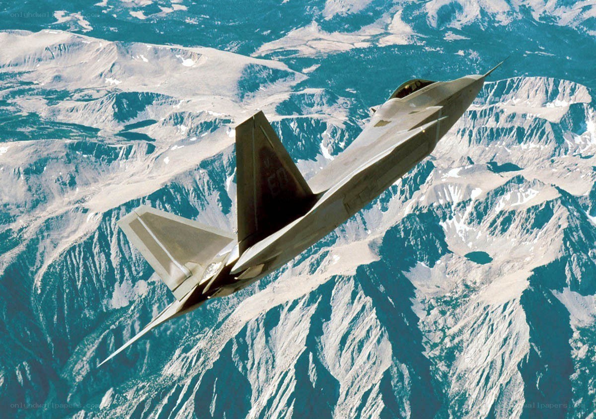 F-22 Raptor flying over mountains