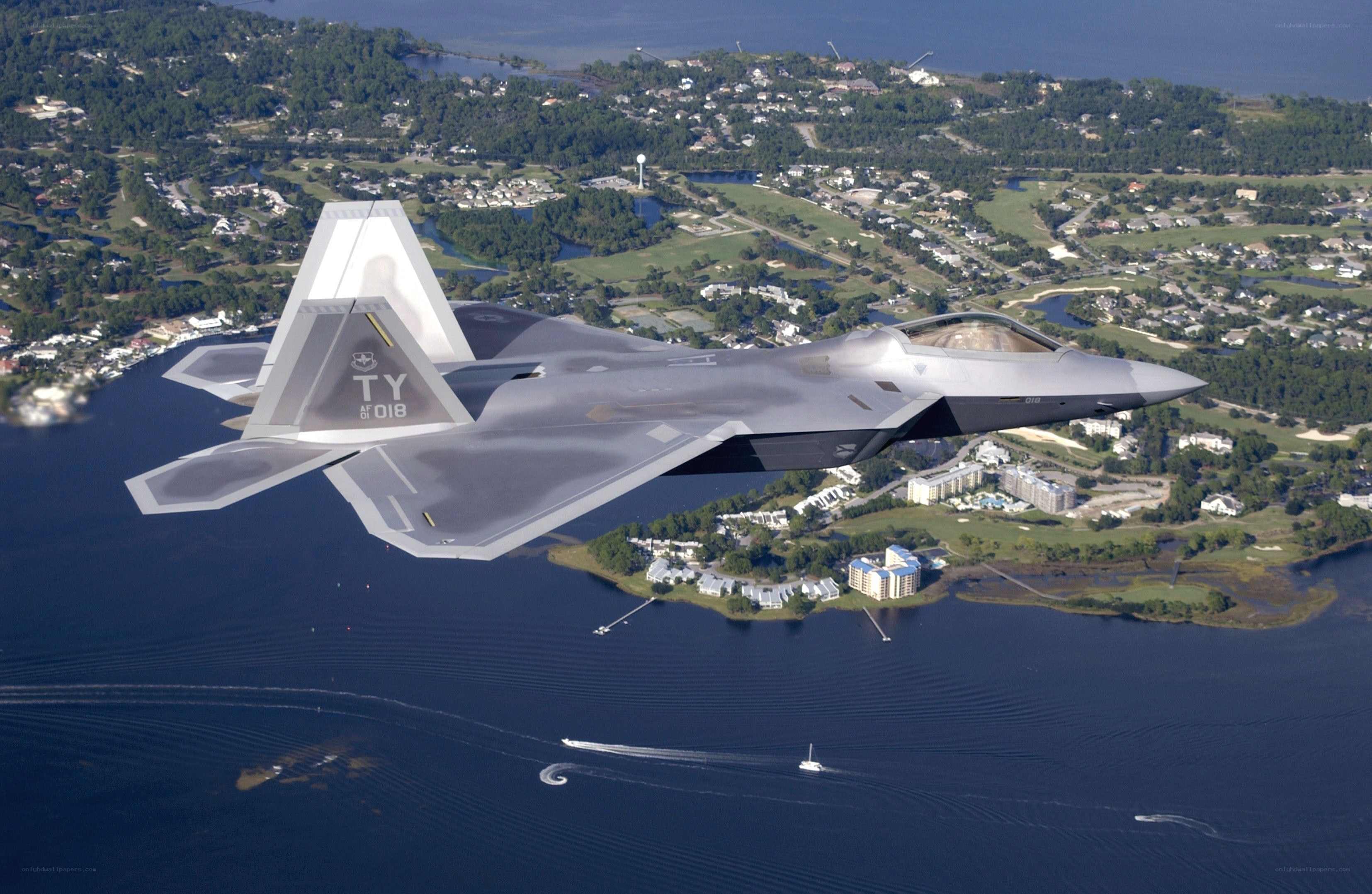 F-22 Raptor in flight over water